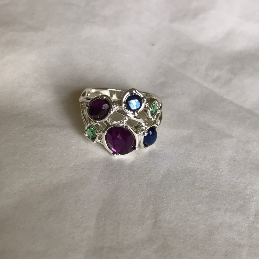 Silver-tone ring with purple, blue, green beads.